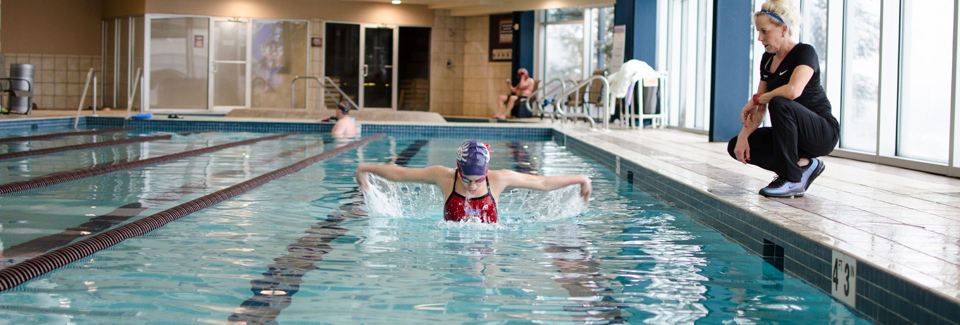 person swimming in an indoor pool